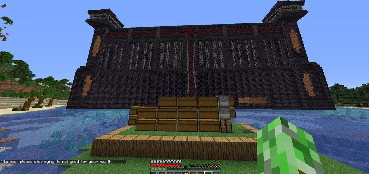 A screenshot from Sam's stream. He's standing outside the prison on a small island with a few chests. The outside is made of blackstone, obisdian, and iron bars. Netherrack and redstone lamps decorate the outside of the prison.